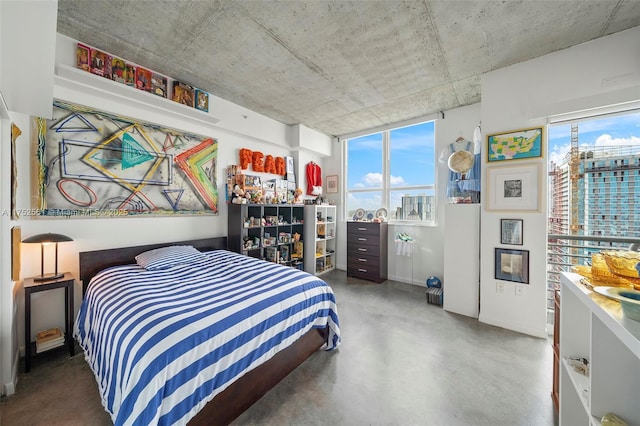 bedroom with concrete flooring and a view of city