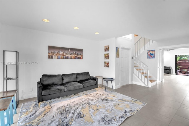 living area featuring stairs, baseboards, and recessed lighting