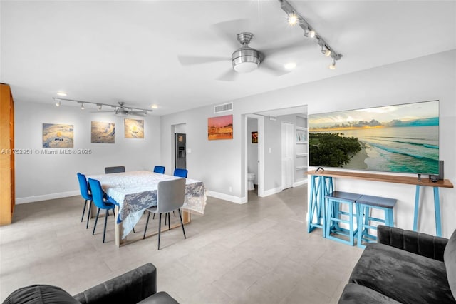 dining room with baseboards, built in features, visible vents, and a ceiling fan