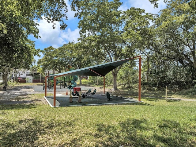 view of home's community featuring playground community and a yard