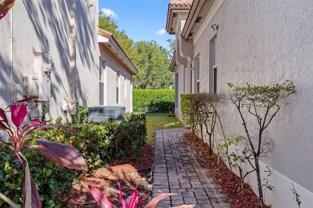 view of property exterior with central AC unit and stucco siding