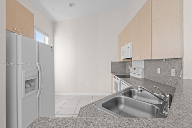 kitchen with light tile patterned floors, backsplash, light brown cabinets, a sink, and white appliances