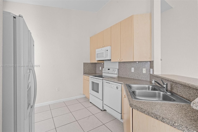 kitchen with tasteful backsplash, white appliances, light brown cabinets, and light tile patterned floors