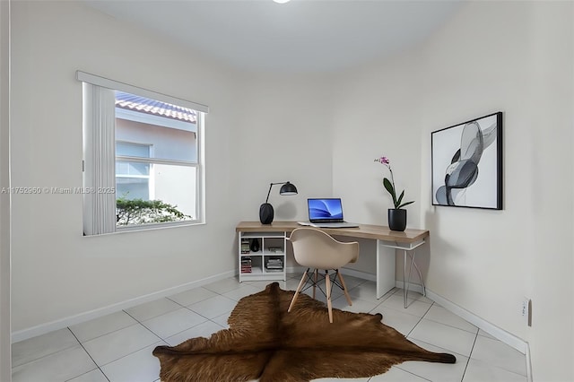 office space with baseboards and light tile patterned floors