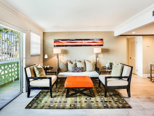 living area with baseboards, wood finished floors, and crown molding