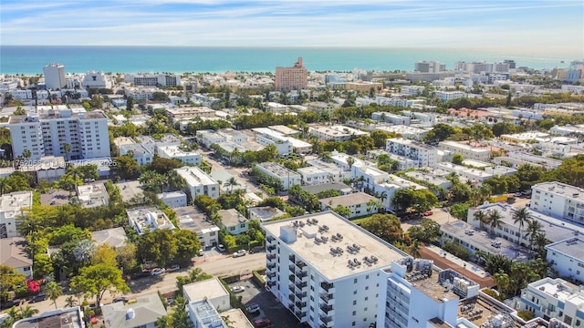 birds eye view of property with a water view and a city view