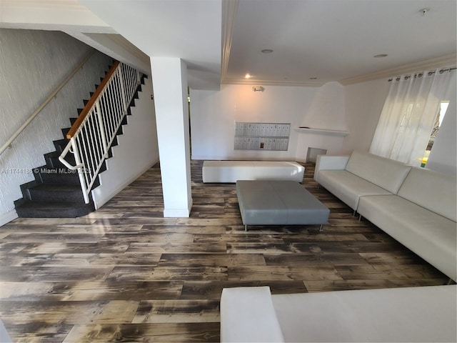 living room with crown molding, stairs, dark wood-type flooring, and recessed lighting