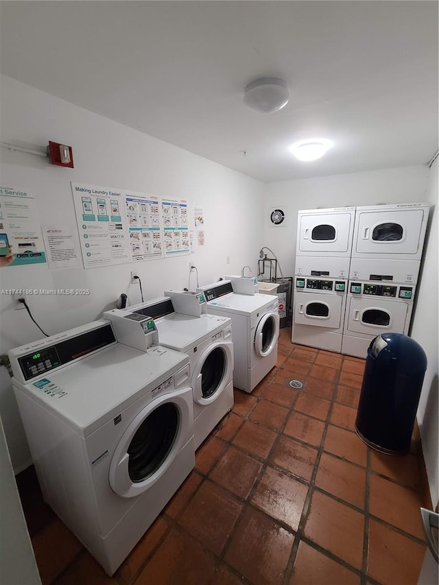 community laundry room featuring stacked washer / drying machine and washing machine and clothes dryer