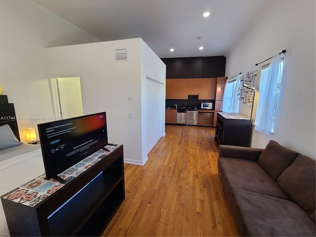 living room featuring recessed lighting, visible vents, and light wood-style floors