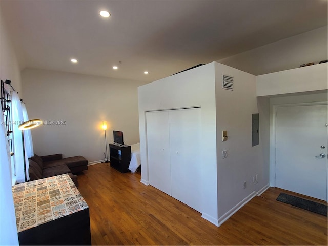 interior space featuring baseboards, wood finished floors, visible vents, and recessed lighting