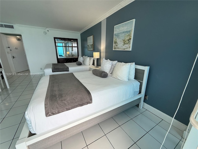 bedroom with light tile patterned floors, baseboards, visible vents, and ornamental molding