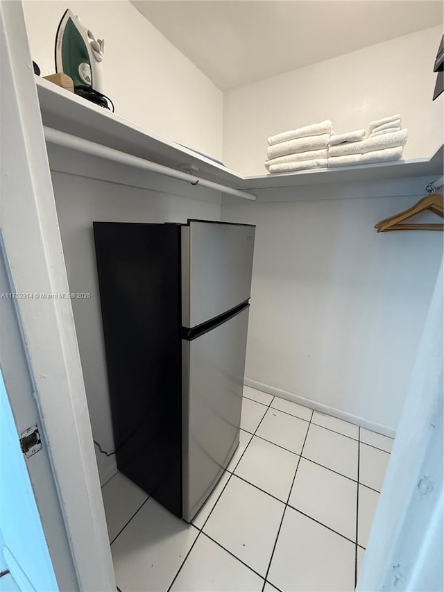 walk in closet featuring light tile patterned flooring