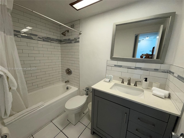 full bath with tile patterned flooring, toilet, vanity, decorative backsplash, and shower / tub combo with curtain