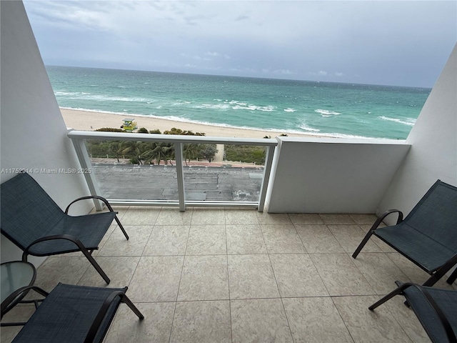 balcony with a water view and a beach view