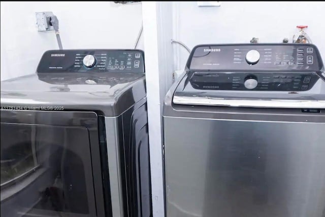 laundry room featuring washing machine and dryer and laundry area