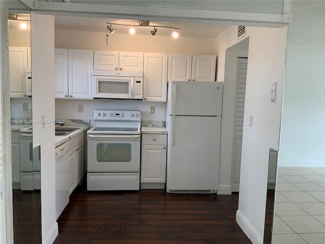 kitchen with light countertops, dark wood-type flooring, white cabinets, white appliances, and baseboards