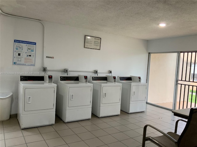 common laundry area with a textured ceiling, light tile patterned floors, and washer and dryer