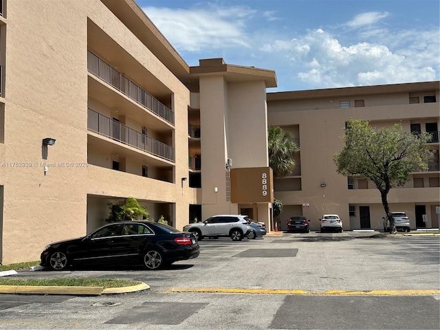 view of building exterior featuring uncovered parking