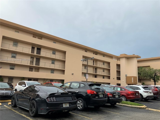 view of building exterior featuring uncovered parking