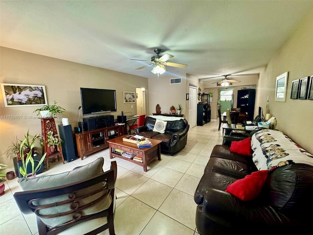 living area with light tile patterned floors, visible vents, and a ceiling fan