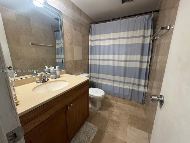 bathroom featuring curtained shower, tile walls, toilet, and vanity
