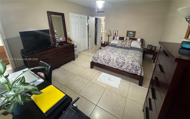 bedroom with visible vents, a closet, and light tile patterned floors