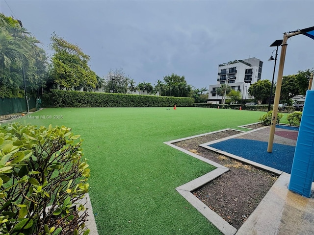 view of home's community featuring fence and a lawn