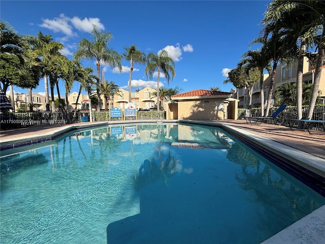 pool with a residential view and fence