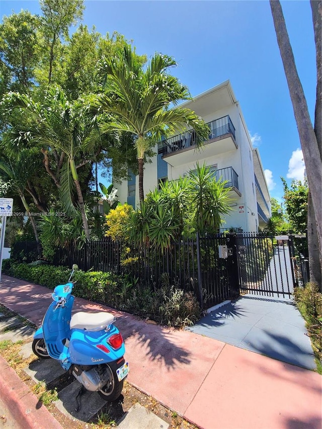 view of home's exterior with fence and stucco siding