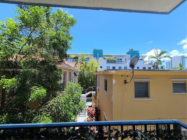 exterior space with a balcony and stucco siding