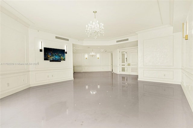 unfurnished room with a chandelier, a decorative wall, and crown molding