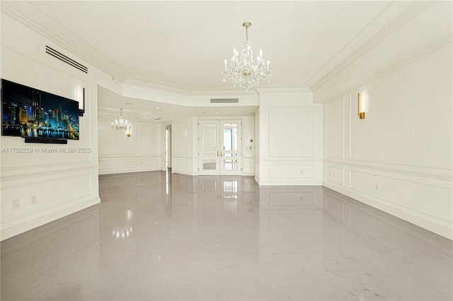 unfurnished room with a notable chandelier, ornamental molding, visible vents, and a decorative wall