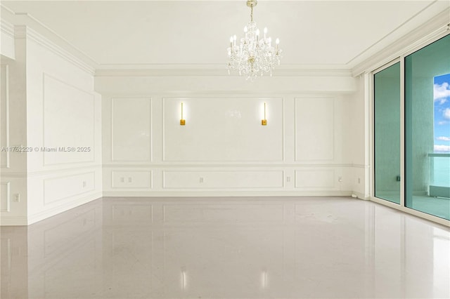 unfurnished room featuring a chandelier, ornamental molding, and a decorative wall