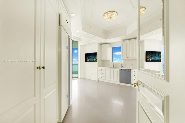 kitchen featuring dishwasher, ornamental molding, a tray ceiling, light countertops, and white cabinetry