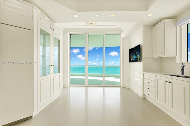 interior space featuring ornamental molding, a sink, and recessed lighting