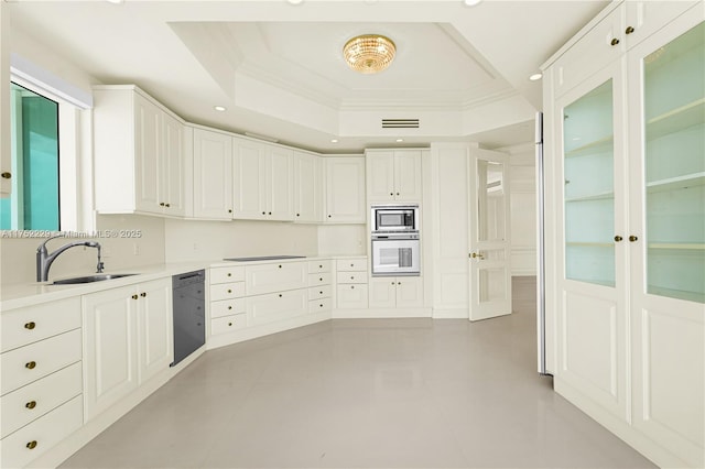 kitchen featuring white cabinets, a raised ceiling, light countertops, black appliances, and a sink