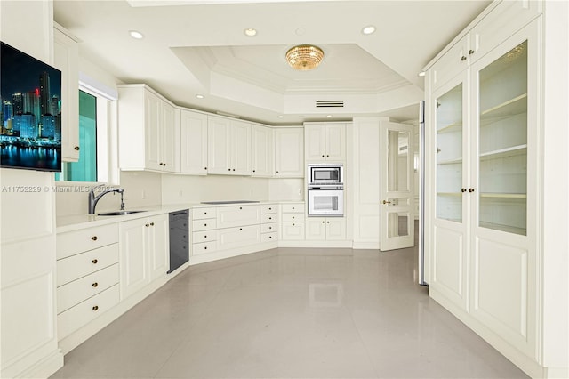 kitchen featuring stainless steel microwave, a raised ceiling, oven, and recessed lighting