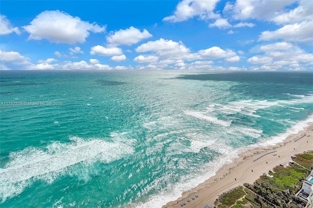 bird's eye view featuring a water view and a beach view