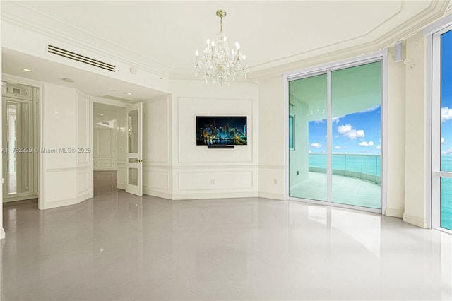 spare room featuring crown molding, visible vents, a decorative wall, and an inviting chandelier