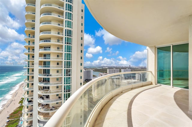 balcony with a beach view and a water view