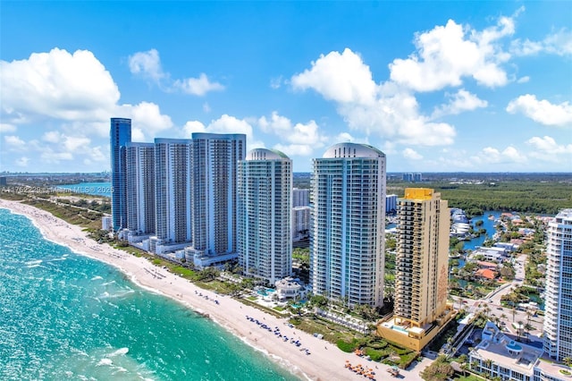 bird's eye view featuring a water view, a beach view, and a city view