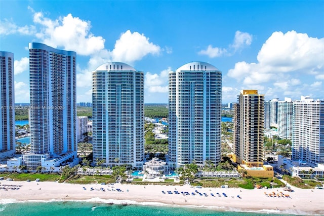 exterior space featuring a water view, a beach view, and a city view