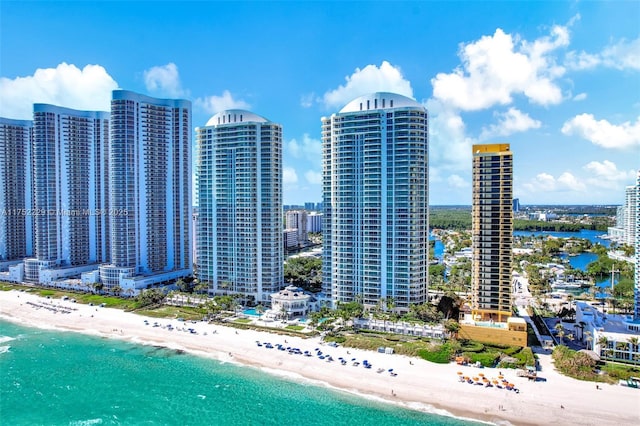 aerial view featuring a city view, a water view, and a beach view