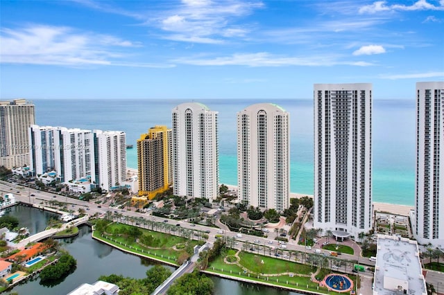 birds eye view of property featuring a water view and a city view