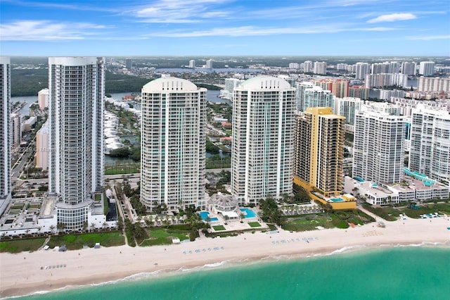 bird's eye view featuring a city view, a water view, and a beach view