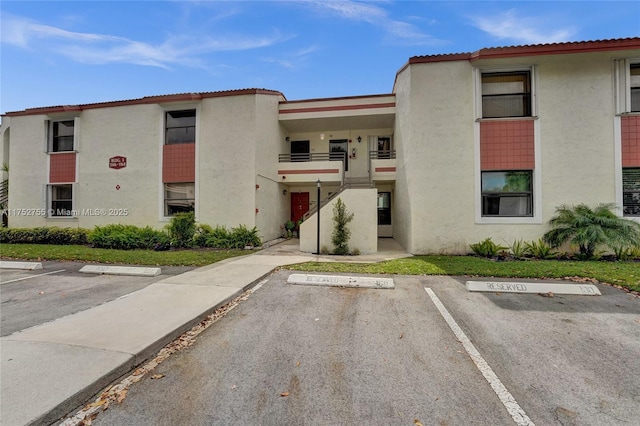 view of property featuring uncovered parking