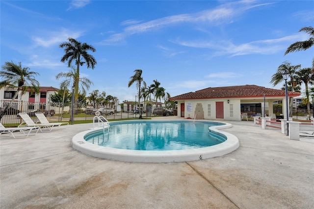 pool with fence and a patio