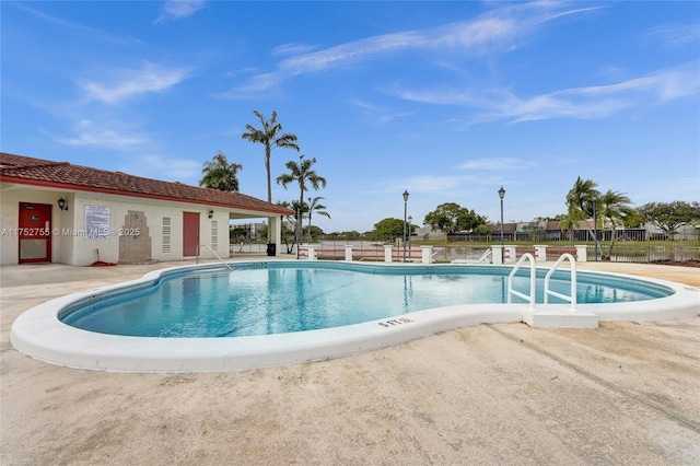 pool featuring fence and a patio