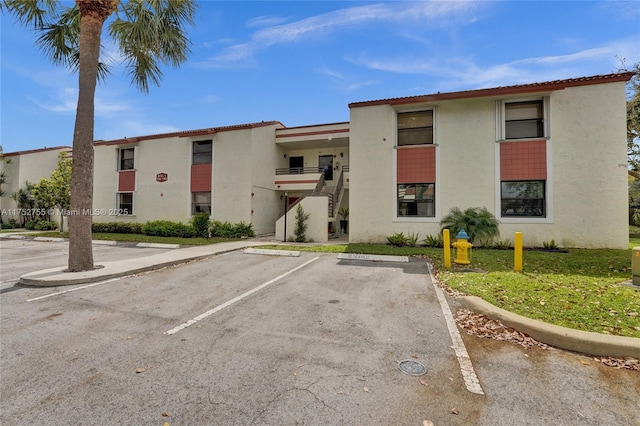 view of building exterior featuring uncovered parking