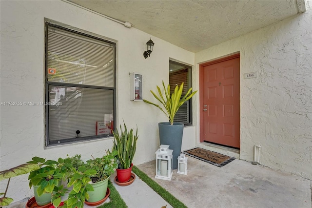 entrance to property featuring stucco siding